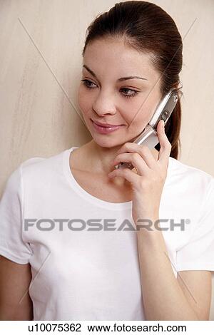 Stock Image - Woman talking on cell phone. Fotosearch
