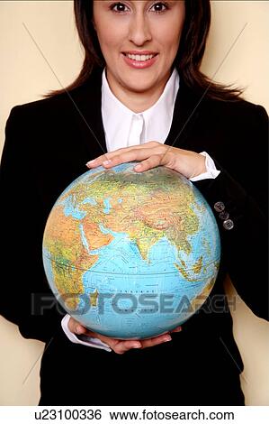 Stock Photograph - A woman holding a globe . Fotosearch