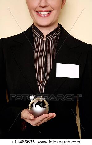 Stock Photography -  A woman holding a globe . Fotosearch
