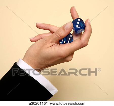 A woman holding a pair of blue dice View Large Photo Image Stock Image - A woman holding a pair of blue dice . Fotosearch