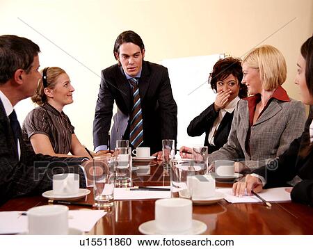 Stock Image -  A group of business people at a meeting. Fotosearch