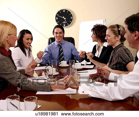 Stock Image -  A group of business people at a meeting. Fotosearch