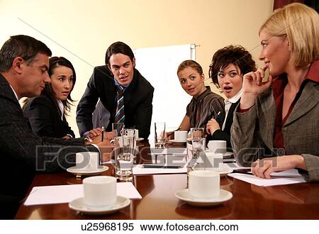 Stock Photography -  A group of business people at a meeting. Fotosearch