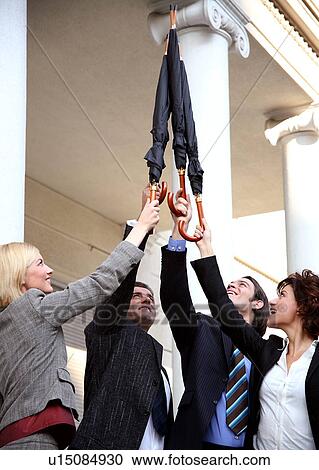Stock Image -  Business people reaching for the sky. Fotosearch