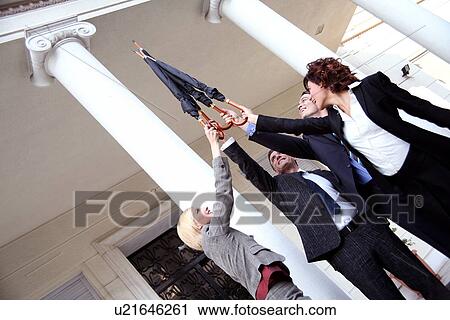 Stock Image -  Business people reaching for the sky. Fotosearch