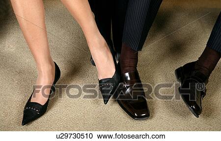 Stock Image - Man and Woman playing footsie. Fotosearch