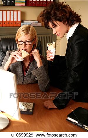 Two women working at the computer View Large Photo Image Stock Photography - Two women working at the computer. Fotosearch