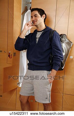 Man in locker room after work out talking on cell phone View Large Photo Image Stock Image - Man in locker room after work out talking on cell phone. Fotosearch
