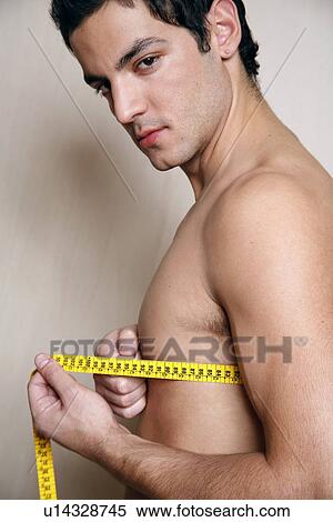 Stock Photography - Man measuring his chest. Fotosearch