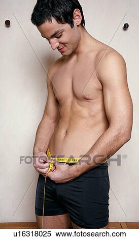 Stock Photography - Man measuring his waist. Fotosearch
