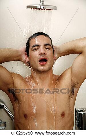 Stock Image - Man taking a shower at the gym. Fotosearch