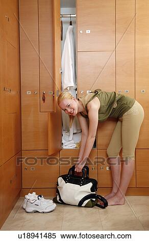 Woman in locker room after work out View Large Photo Image Stock Photography - Woman in locker room after work out. Fotosearch