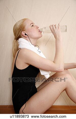 Woman relaxing in locker room after the gym View Large Photo Image Stock Image - Woman relaxing in locker room after the gym. Fotosearch