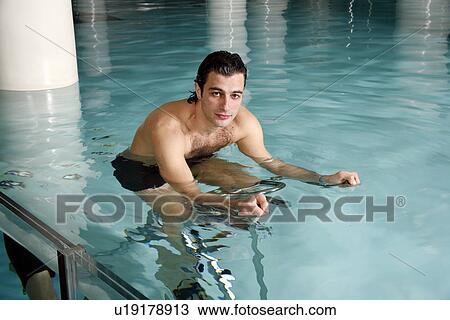 Young man on exercise bike in spa pool View Large Photo Image Stock Image - Young man on exercise bike in spa pool. Fotosearch