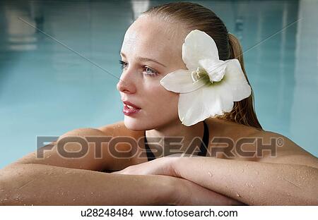 Picture - Young woman in a swimming pool at a spa. Fotosearch