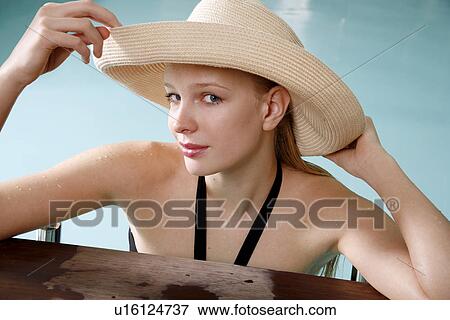 Stock Photo - Young woman in a swimming pool at a spa. Fotosearch