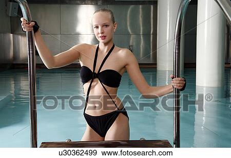 Young woman in a swimming pool at a spa View Large Photo Image Stock Photo - Young woman in a swimming pool at a spa. Fotosearch