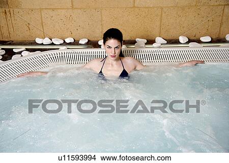 Picture - Young woman in jacuzzi at a spa. Fotosearch