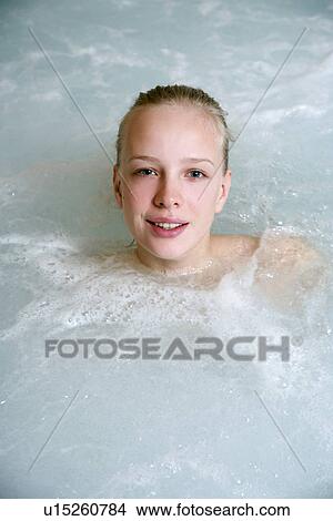 Picture - Young woman in jacuzzi at a spa. Fotosearch