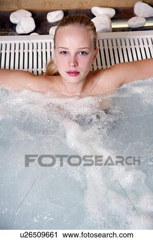 Stock Image - Young woman in jacuzzi at a spa. Fotosearch