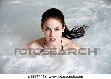 Young woman in jacuzzi at a spa View Large Photo Image Stock Photo - Young woman in jacuzzi at a spa. Fotosearch