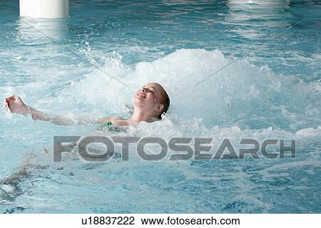 Young woman swimming in spa pool View Large Photo Image Stock Image - Young woman swimming in spa pool. Fotosearch