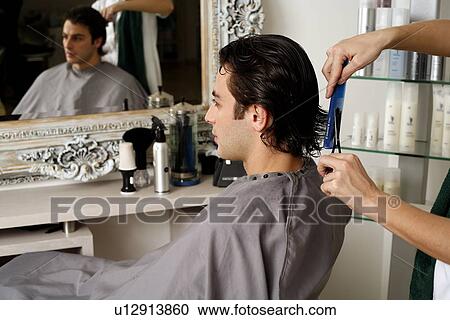 Young man having a haircut View Large Photo Image Stock Image - Young man having a haircut. Fotosearch