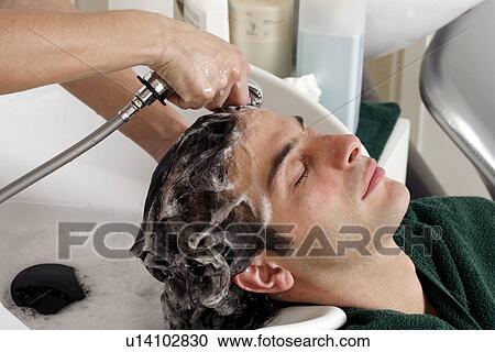 Young man having his hair washed at a salon View Large Photo Image Stock Image - Young man having his hair washed at a salon. Fotosearch