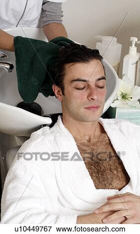 Stock Photo - Young man having his hair washed at a salon. Fotosearch