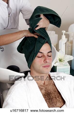 Stock Photo - Young man having his hair washed at a salon. Fotosearch