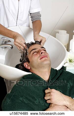 Young man having his hair washed at a salon View Large Photo Image Stock Photography - Young man having his hair washed at a salon. Fotosearch