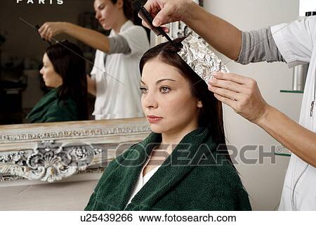 Stock Photograph - Young woman having her hair colored. Fotosearch