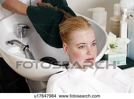 Young woman having her hair washed at a salon View Large Photo Image Picture - Young woman having her hair washed at a salon. Fotosearch