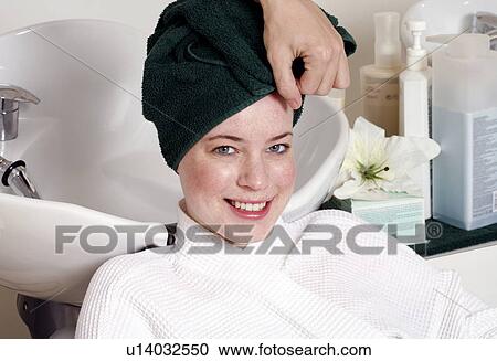 Young woman having her hair washed at a salon View Large Photo Image Stock Image - Young woman having her hair washed at a salon. Fotosearch