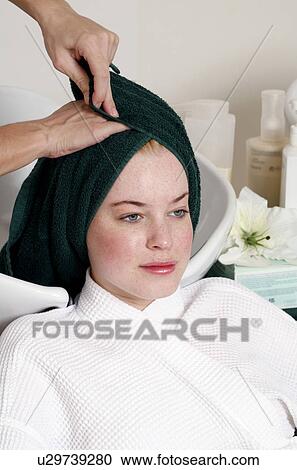 Young woman having her hair washed at a salon View Large Photo Image Stock Image - Young woman having her hair washed at a salon. Fotosearch