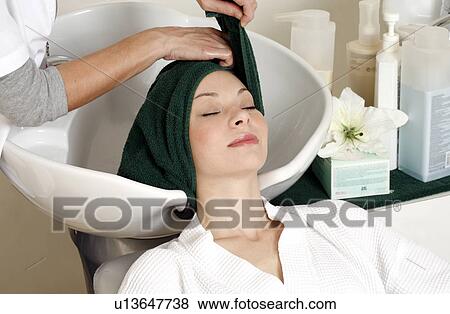 Young woman having her hair washed at a salon View Large Photo Image Stock Photo - Young woman having her hair washed at a salon. Fotosearch