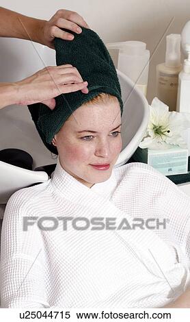 Young woman having her hair washed at a salon View Large Photo Image Stock Photography - Young woman having her hair washed at a salon. Fotosearch