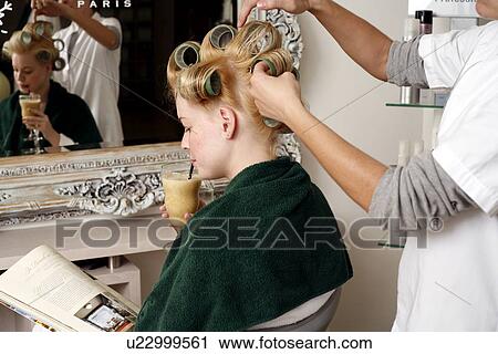 Young woman sitting under hairdryer View Large Photo Image Stock Image - Young woman sitting under hairdryer. Fotosearch