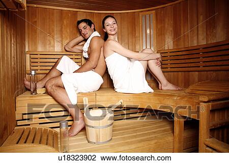 Stock Image - A couple enjoying a sauna together. Fotosearch