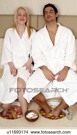 A young couple enjoying a foot bath with rose petals View Large Photo Image Picture - A young couple enjoying a foot bath with rose petals. Fotosearch