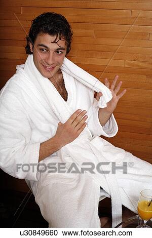 Stock Image - A young man having a refreshment after a spa treatment. Fotosearch