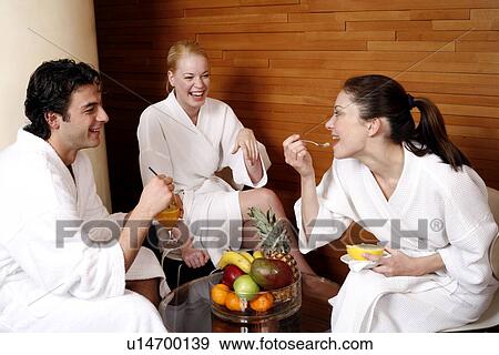 Stock Photo - Friends having a refreshment after a spa treatment. Fotosearch