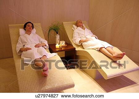 Two young women relaxing at a spa together View Large Photo Image Stock Photo - Two young women relaxing at a spa together. Fotosearch