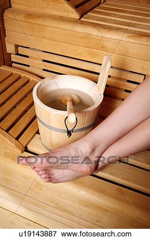 Stock Photo - Water bucket with ladle in a sauna. Fotosearch