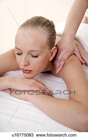 Young woman enjoying a massage View Large Photo Image Stock Image - Young woman enjoying a massage . Fotosearch