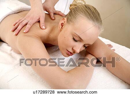 Young woman enjoying a massage View Large Photo Image Stock Photo - Young woman enjoying a massage . Fotosearch