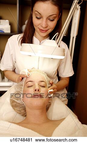 Woman having a facial treatment at a spa View Large Photo Image Stock Image - Woman having a facial treatment at a spa. Fotosearch