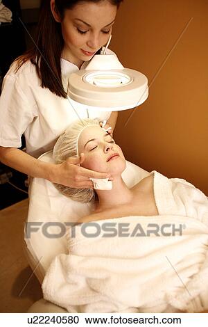 Woman having a facial treatment at a spa View Large Photo Image Stock Image - Woman having a facial treatment at a spa. Fotosearch