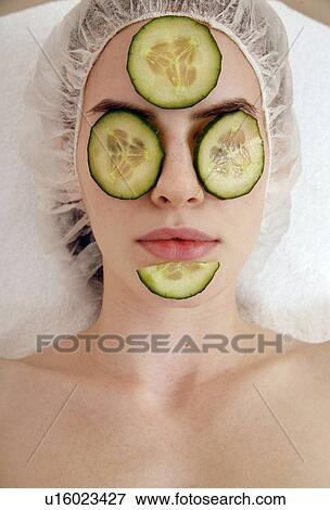 Stock Photo - Woman having a facial treatment in a spa. Fotosearch