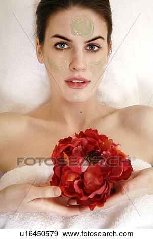 Stock Photo - Woman having a facial treatment in a spa. Fotosearch